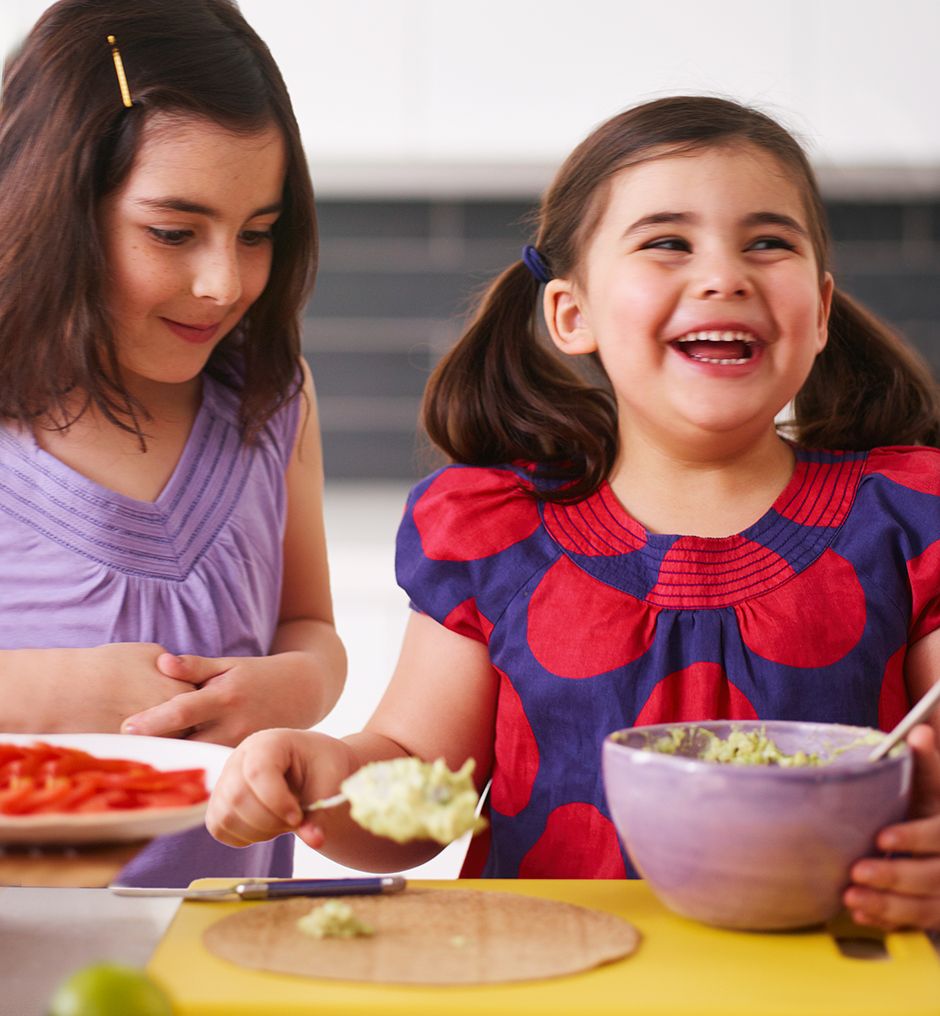 two girls making hummus