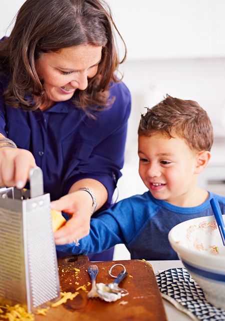 lady and boy grating cheese